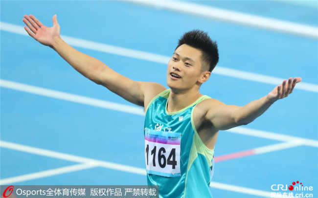 Xie Zhenye celebrates after winning the men's 100m title at 13th Chinese National Games in north China's Tianjin Municipality, Sept. 3, 2017. [Photo: cri.cn]