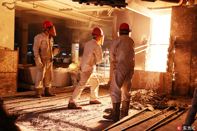 Workers work at a factory. [File Photo: IC]
