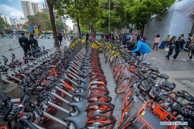Ctizens use shared bicycles in Kunming, capital of southwest China's Yunnan Province. [Photo: Xinhua/Hu Chao]