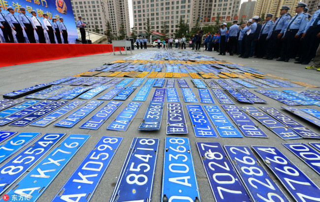 Local police in Lanzhou, the capital city of Gansu province, destroy around 836 illegal license plates on Wednesday. [Photo: China Plus]