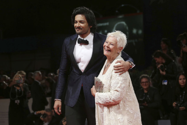 Actors Ali Fazal, left, and Judi Dench pose for photographers at the premiere of the film 'Victoria and Abdul' during the 74th edition of the Venice Film Festival in Venice, Italy, Sunday, Sept. 3, 2017. [Photo: AP/Joel Ryan]