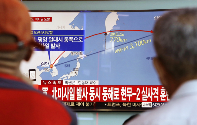 People in South Korea watch a TV screen reporting a DPRK's missile launch on Sept. 15, 2017. [Photo: AP]