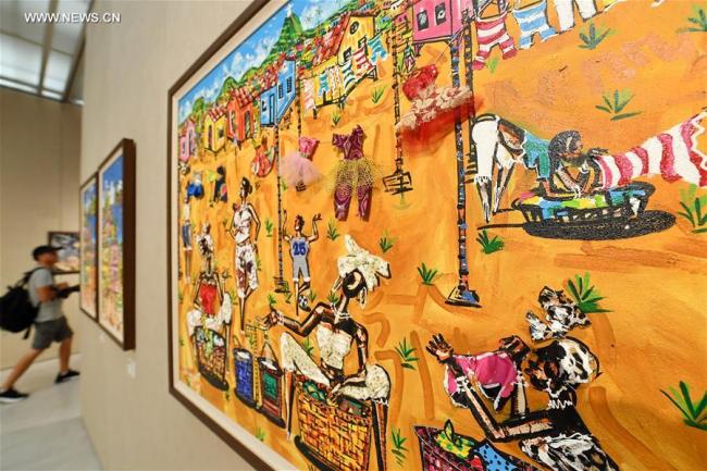 Art works are displayed during an exhibition of paintings and photos of the BRICS countries in Xiamen, southeast China's Fujian Province, Sept. 15, 2017. [Photo: Xinhua/Lin Shanchuan]