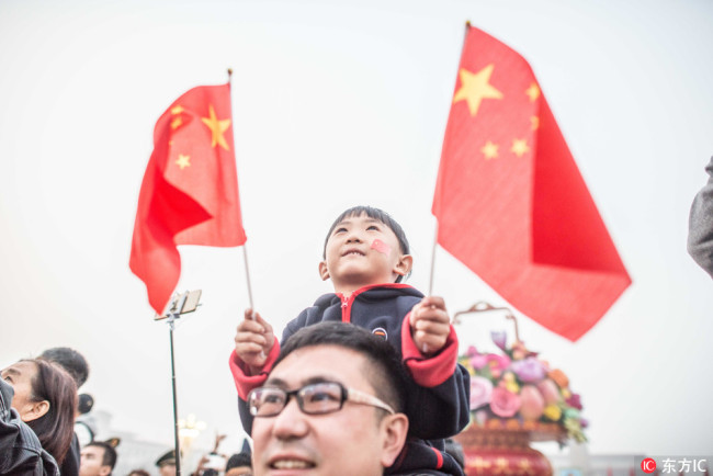 At day break, more than 115,000 people from across China gathered at the Tian'anmen Square at the heart of Beijing to watch the raising of the National Flag on Oct 1 2017. [Photo: IC]