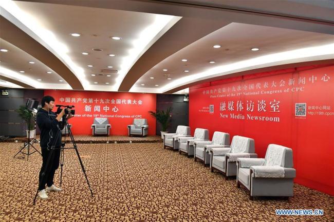 A journalist takes video in the new media newsroom of the Press Center of the 19th National Congress of the Communist Party of China in Beijing, capital of China, Oct. 11, 2017.[Photo: Xinhua]