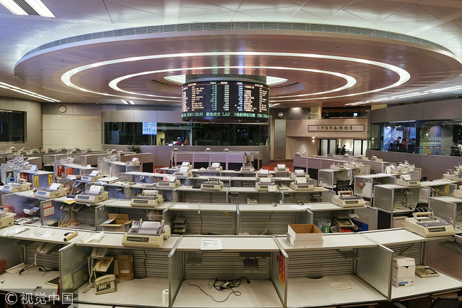 Emptied booths stand on the trading floor of the Hong Kong Stock Exchange, operated by Hong Kong Exchanges & Clearing Ltd. (HKEX), in Hong Kong, China, on Tuesday, Oct. 24, 2017. HKEX will shut its iconic Trading Hall on Oct. 27, 31 years after opening the space in the heart of the city's financial district. [Photo: VCG/Bloomberg via Getty Images/Anthony Kwan]