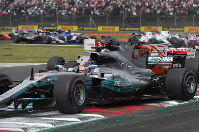 Pieces from Sebastian Vettel's Ferrari fly after it touched with Lewis Hamilton's Mercedes on a turn of the first lap of the Formula One Mexico Grand Prix auto race at the Hermanos Rodriguez racetrack in Mexico City, Sunday, Oct. 29, 2017. [Photo: AP]