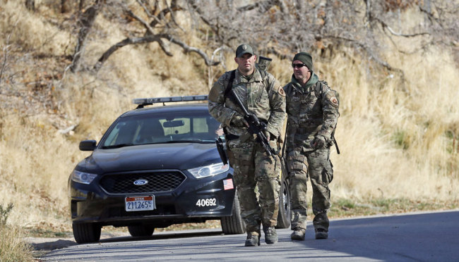 Law enforcement search of the hills near the mouth of Red Butte Canyon, Tuesday, Oct. 31, 2017, in Salt Lake City. A fatal carjacking attempt near the University of Utah late Monday left one student dead and touched off a campus-wide lockdown as hundreds of police officers swarmed buildings and nearby foothills and canyons in search of the suspected gunman. [Photo: AP]