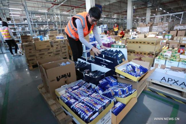 Staff members of a cross-border e-commerce company check stock in Ningbo, east China's Zhejiang Province, Nov. 8, 2017. Cross-border e-commerce companies and courier services in Ningbo are busy preparing for the Singles' Day shopping spree which falls on Nov.11. [Photo: Xinhua]