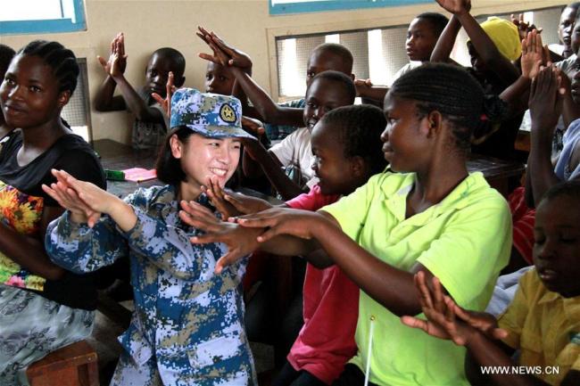 A doctor from the Chinese naval hospital ship Peace Ark teaches children how to wash hands properly at the Kurasini Children's Home in Dar es Salaam, Tanzania, Nov. 21, 2017. [Photo: Xinhua/Li Sibo]