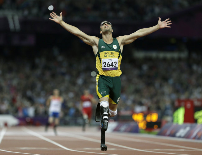 In this Sept. 8, 2012 file photo, South Africa's Oscar Pistorius wins gold in the men's 400-meter T44 final at the 2012 Paralympics in London. The biggest moment of Pistorius' career. Pistorius competes at the London Olympics, where he makes the semifinals in his favored event, the 400 meters. [File Photo: AP Photo/Kirsty Wigglesworth]