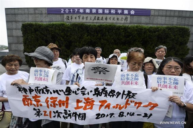 Members of an anti-war NGO based in Kobe, Japan attend a peace assembly at the Memorial Hall of the Victims in Nanjing Massacre by Japanese Invaders in Nanjing, capital of east China's Jiangsu Province, Aug. 15, 2017. Representatives from countries such as China, Japan, Pakistan, Bangladesh and Jordan attended the assembly to commemorate the 72nd anniversary of Japan's unconditional surrender in World War II. [Photo: Xinhua/Ji Chunpeng]