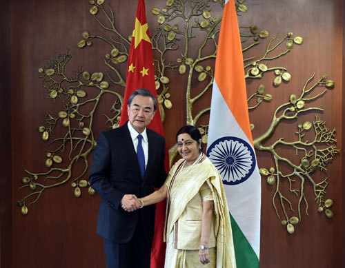 Chinese Foreign Minister Wang Yi (L) meets with Indian External Affairs Minister Sushma Swaraj on the sidelines of the 15th trilateral meeting of foreign ministers from China, Russia and India in New Delhi, India on Monday, December 11, 2017. [Photo: fmprc.gov.cn]