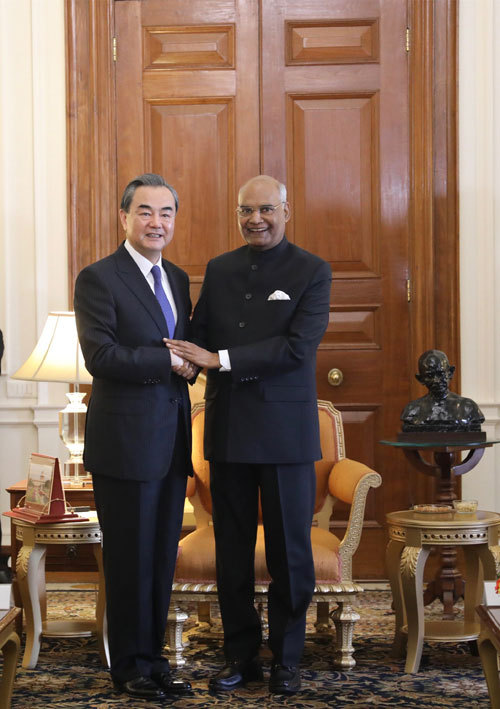 The Indian president (right) met with Chinese Foreign Minister Wang Yi (left) on Monday. [Photo: fmprc.gov.cn]