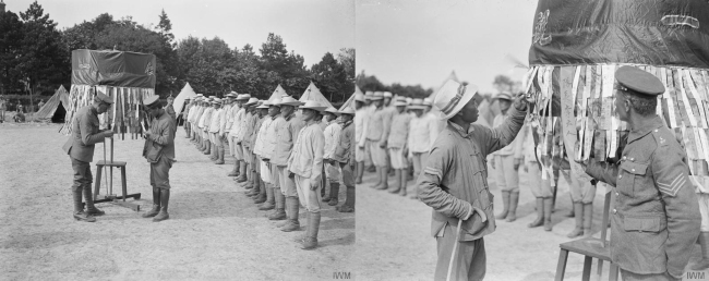 Sergeant of the Royal Fusiliers and Chinese worker during roll call at the Chinese Labour Corps Camp at Samer, 26 May 1918 [Photos: IWM, London]