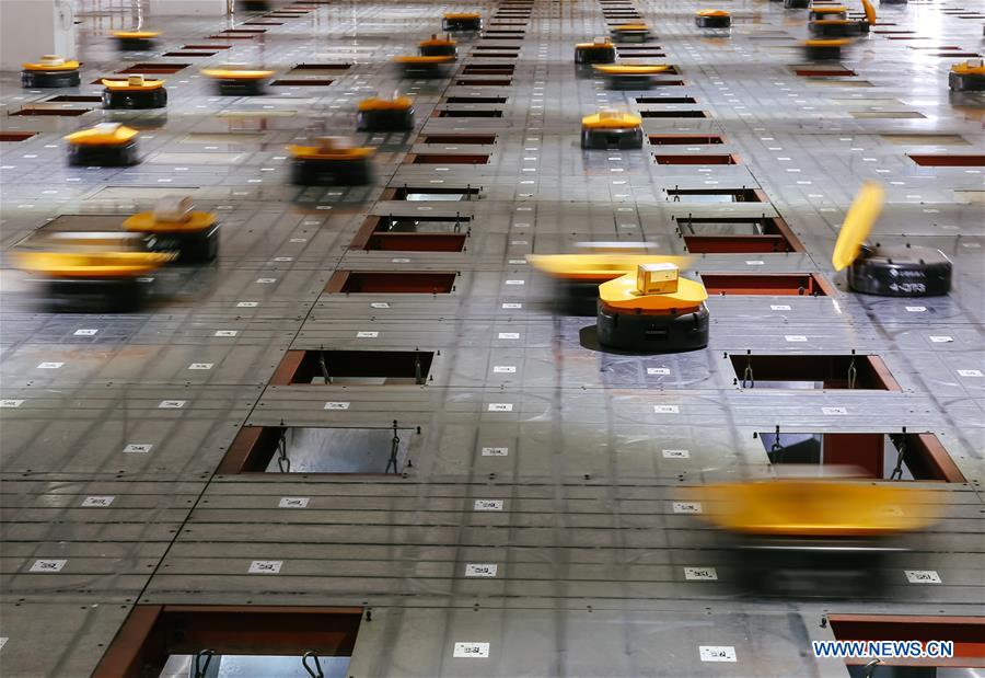 Automated guided robots sort goods at sto express in Yiwu, east China's Zhejiang Province, May 3, 2017.