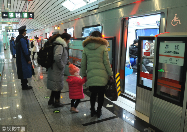 Passengers take the driverless Yanfang Subway Line in Beijing on December 30, 2017. [Photo: VCG]