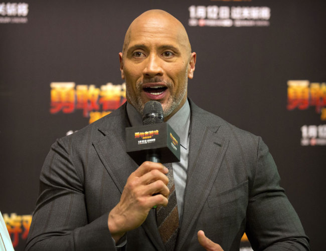 American actor Dwayne Johnson speaks to fans as he arrives for a press conference for the movie 'Jumanji: Welcome to the Jungle' in Beijing, Thursday, Jan. 4, 2018. The hit movie opens in China on Jan. 12. [Photo: AP/Mark Schiefelbein]