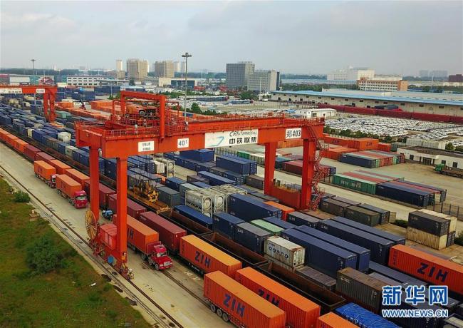 At a rail freight terminal in Zhengzhou, containers are being loaded to freight trains departing to Europe from Zhengzhou. [Photo: Xinhua]
