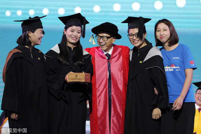 Hong Kong business magnate Li Ka Shing (center) takes a group photo with the four members of Kung Fu Cha Cha during a graduation ceremony at Shantou University on June 27, 2017. [Photo: VCG]