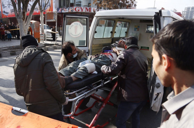 People help carry an injured man to the hospital following a suicide attack in Kabul, Afghanistan, Saturday Jan. 27, 2018. [Photo: AP]