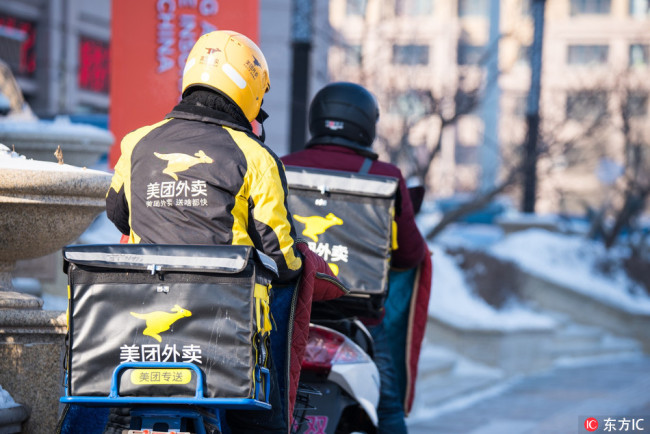 Food delivery riders work after snow in Harbin, Heilongjiang Province, on January 18, 2018. [File photo: IC]