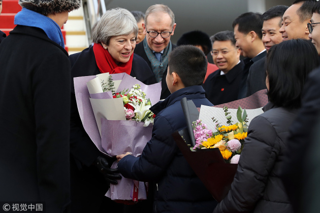 British Prime Minister Theresa May is greeted by children at Wuhan airport on January 31, 2018 in Wuhan, Hubei Province. [Photo: VCG]