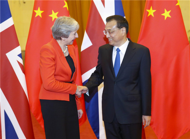 Chinese Premier Li Keqiang (R) holds a welcome ceremony for visiting British Prime Minister Theresa May at the Great Hall of the People in Beijing on Wednesday, January 31, 2018. [Photo: gov.cn]