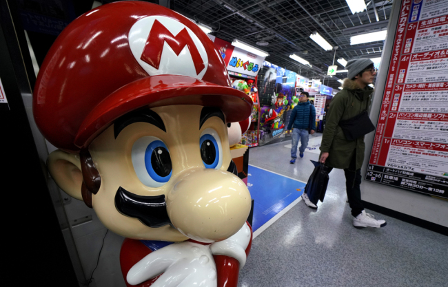 A Super Mario figure greets shoppers at an electronics store in Tokyo, Wednesday, Jan. 31, 2018. [Photo: AP/Shizuo Kambayashi]