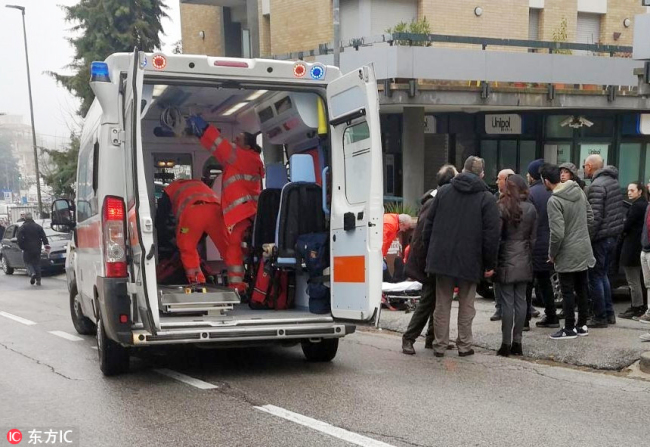 One of the injured persons rescued by healthcare professional after being shot by gun fire from a vehicle on passersby in the central Italian town of Macerata, February 3, 2018. [Photo: IC/ANSA/Guido Picchio]