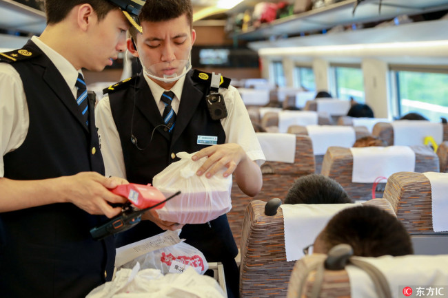 Railway staffs deliver the meal to passengers who order food online on a high-speed bullet train at the Nanjing South Railway Station in Nanjing city, east China´s Jiangsu province, July 21, 2017. [Photo: IC]
