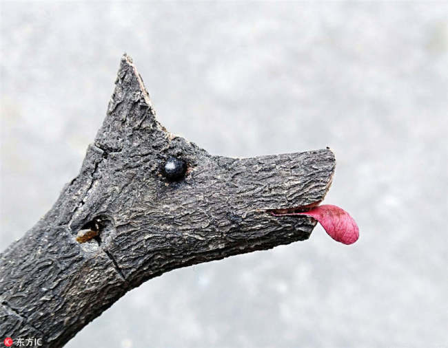A dog image is made of a tree branch. [Photo/IC]