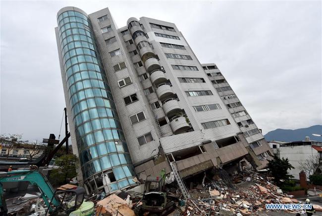 A collapsed building is seen in quake-hit Hualien County, southeast China's Taiwan, Feb. 7, 2018. An earthquake of magnitude 6.5 hit Taiwan late Tuesday, killing seven and injuring 254. [Photo: Xinhua]