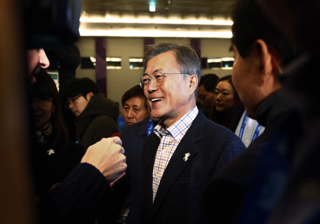 South Korean President Moon Jae-in passes journalists during a visit to the Main Press Center at the 2018 Winter Olympics in Pyeongchang, South Korea, on Saturday, Feb. 17, 2018. [File Photo: AP/Peter Morgan]