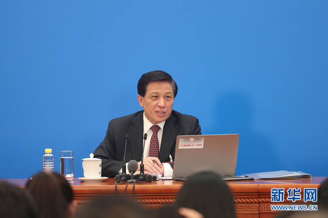 Zhang Yesui, spokesperson of the first session of the 13th National People's Congress (NPC) answers questions from the press in Beijing on March 4, 2018. [Photo: Xinhua]