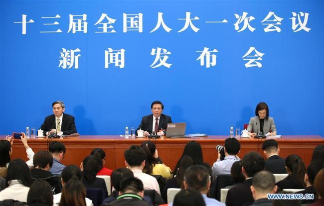 Zhang Yesui (C), spokesperson for the first session of the 13th National People's Congress (NPC), speaks during a press conference on the NPC session at the Great Hall of the People in Beijing, capital of China, March 4, 2018. The first session of the 13th NPC will open in Beijing on March 5. [Photo: Xinhua/Jin Liwang]