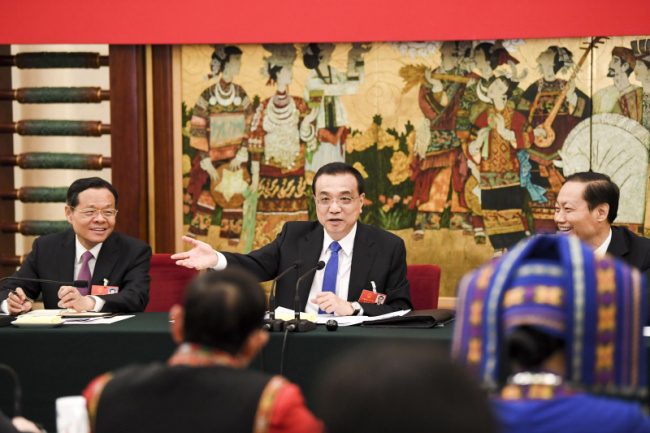 Chinese Premier Li Keqiang joined a panel discussion with deputies from South China’s Guangxi Zhuang autonomous region at the first session of the 13th National People’s Congress in Beijing on March 6.