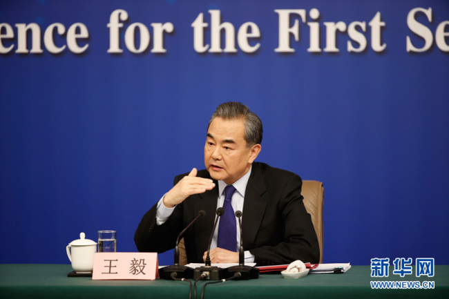Chinese Foreign Minister Wang Yi meets the press on the sidelines of the national legislature's annual session in Beijing on March 8. [Photo: Xinhua]