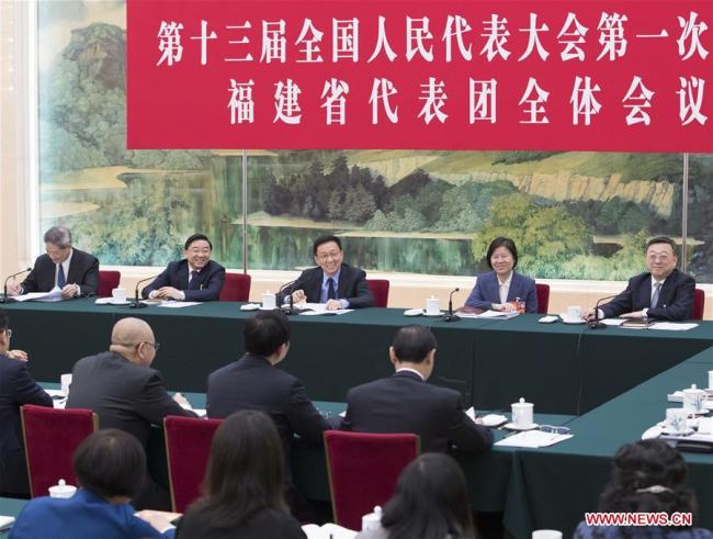 Han Zheng, a member of the Standing Committee of the Political Bureau of the Communist Party of China (CPC) Central Committee, joins a panel discussion with deputies from Fujian Province at the first session of the 13th National People's Congress in Beijing, capital of China, March 8, 2018. [Photo: Xinhua/Wang Ye]