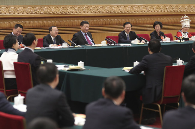 Chinese President Xi Jinping, also general secretary of the Communist Party of China (CPC) Central Committee and chairman of the Central Military Commission, joins a panel discussion with deputies from Chongqing Municipality at the first session of the 13th National People's Congress in Beijing on Saturday, March 10, 2018. [Photo: China News Service]