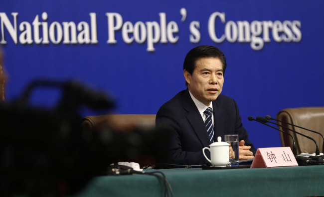 Zhong Shan, head of the Ministry of Commerce, answers questions at a press conference on the sidelines of the first session of the 13th National People's Congress in Beijing, on March 11, 2018. [Photo: China Plus/Li Jin]