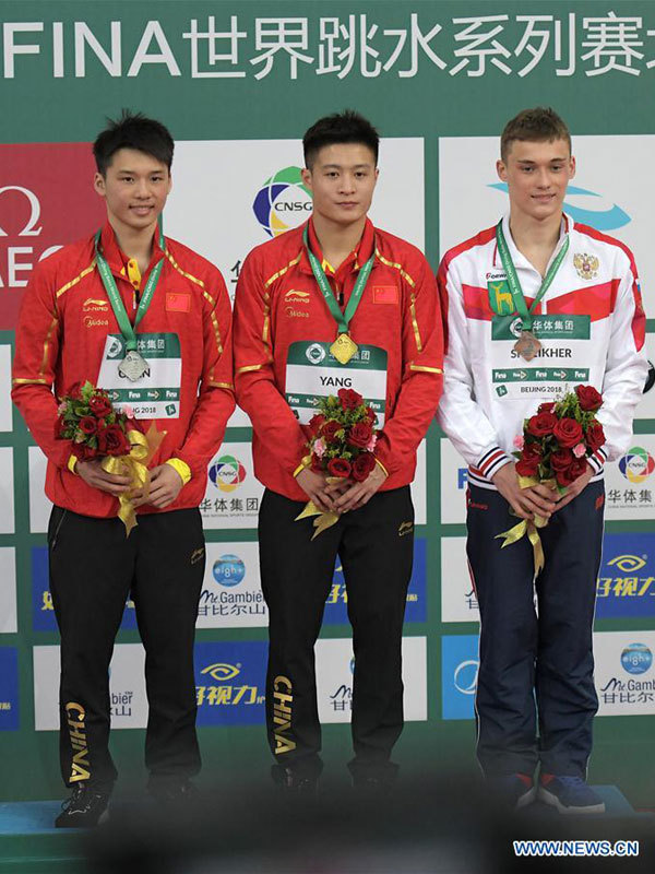 Gold medalist China's Yang Jian (C), silver medalist China's Chen Aisen and bronze medalist Nikita Shleikher of Russia pose during the awarding ceremony for the men's 10m platform event at the FINA Diving World Series 2018 in Beijing, capital of China, on March 11, 2018. [Photo: Xinhua/He Changshan]