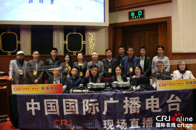 Live broadcast team members of China Radio International pose for a photo ahead of the closing meeting of the First Session of the 13th National Committee of the Chinese People's Political Consultative Conference (CPPCC), the top political advisory body, in Beijing, on March 15, 2018. [Photo: China Plus]