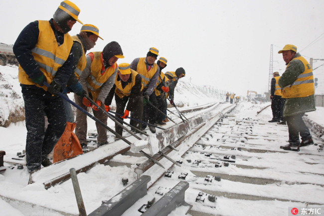 Workers build the Inner Mongolia-Jiangxi Railway in snowy days. [File Photo: IC]