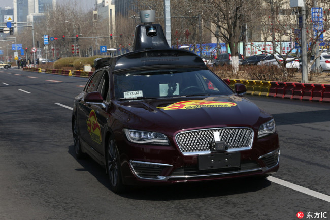 One of Baidu's self-driving vehicles being tested on a public road in Beijing on March 22, 2018. The company won the first approval from authorities for testing self-driving cars on public roads in the city, and was given temporary license plates on Thursday morning. [Photo: IC]