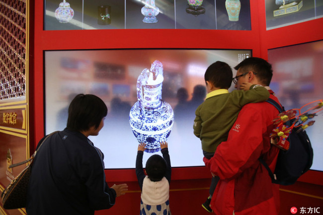 A family was checking details of a relic in the Forbidden City in Beijing.