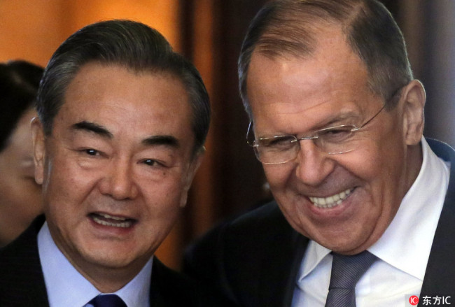 Chinese State Councilor and Foreign Minister Wang Yi (L) and Russian Foreign Minister Sergei Lavrov (R) enter a hall during their meeting in Moscow, Russia, 05 April 2018. Yi is in Moscow for an official visit. [Photo: IC]