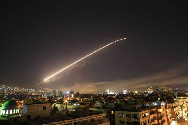 The Damascus sky lights up missile fire as the U.S. launches an attack on Syria targeting different parts of the capital early Saturday, April 14, 2018. [Photo: AP] 