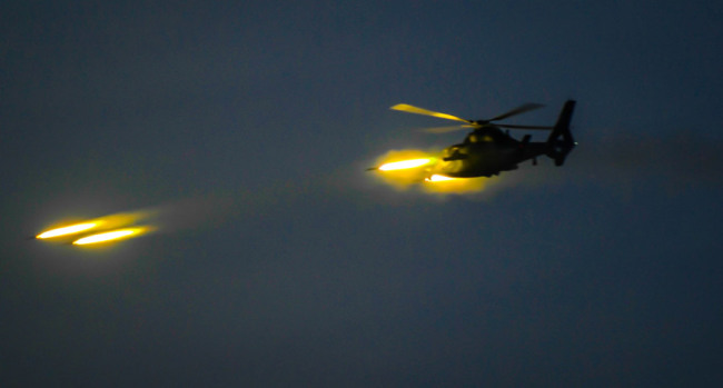 An attack helicopter fires rockets during a live-fire exercise off the country's southeastern coast on April 18, 2018. [Photo: chinadaily.com.cn]