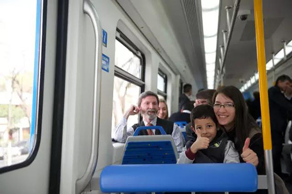 An undated photo shows people riding on a Chinese-produced metro train in Buenos Aires, capital city of Argentina. [Photo: CRRC]